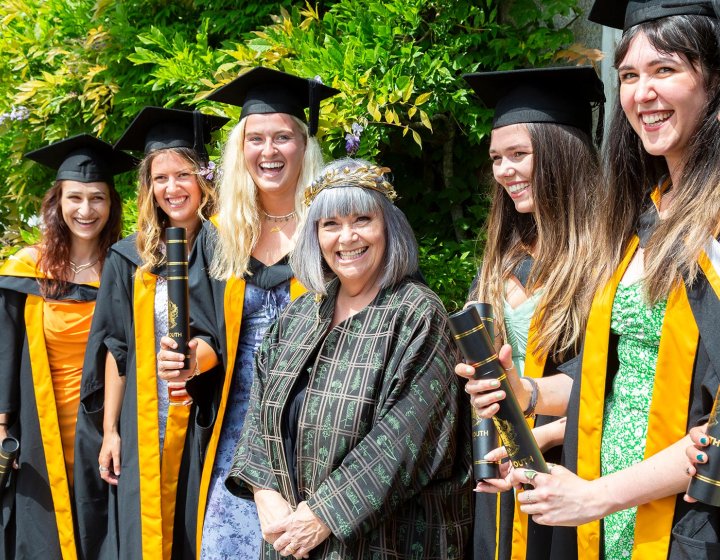 Chancellor Dawn French with female students at Falmouth University graduation ceremony