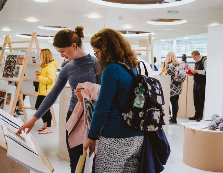 Mother and daughter at a Falmouth University open day looking at art work.