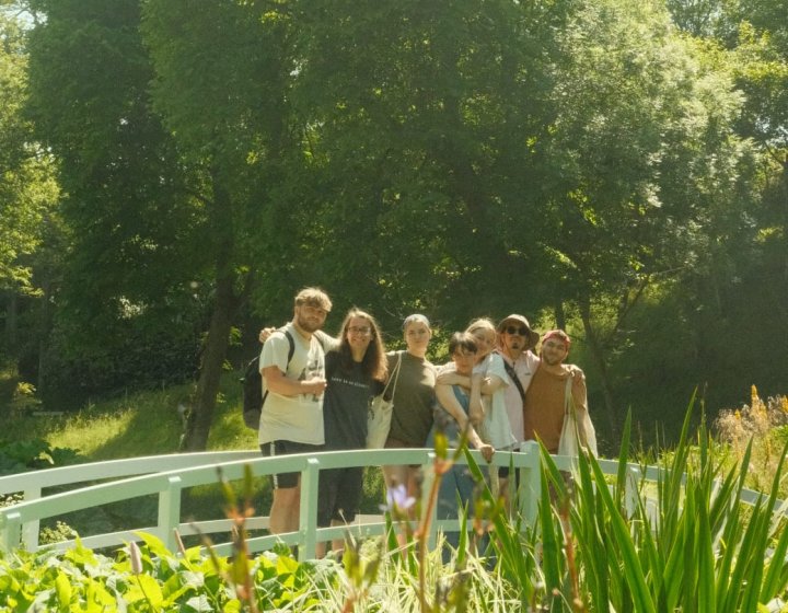 Falmouth students posing on a bridge in a garden