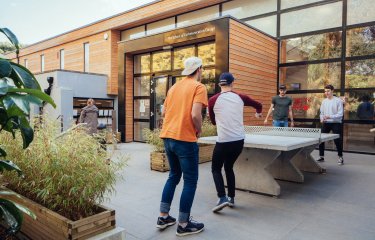 Students playing table tennis on Falmouth campus.