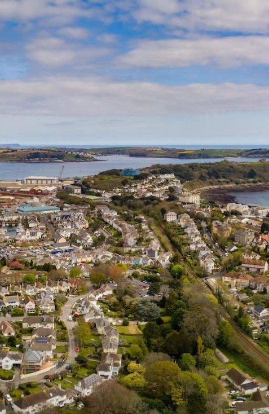 View from above of Falmouth, houses, coastline, sea and clouds.