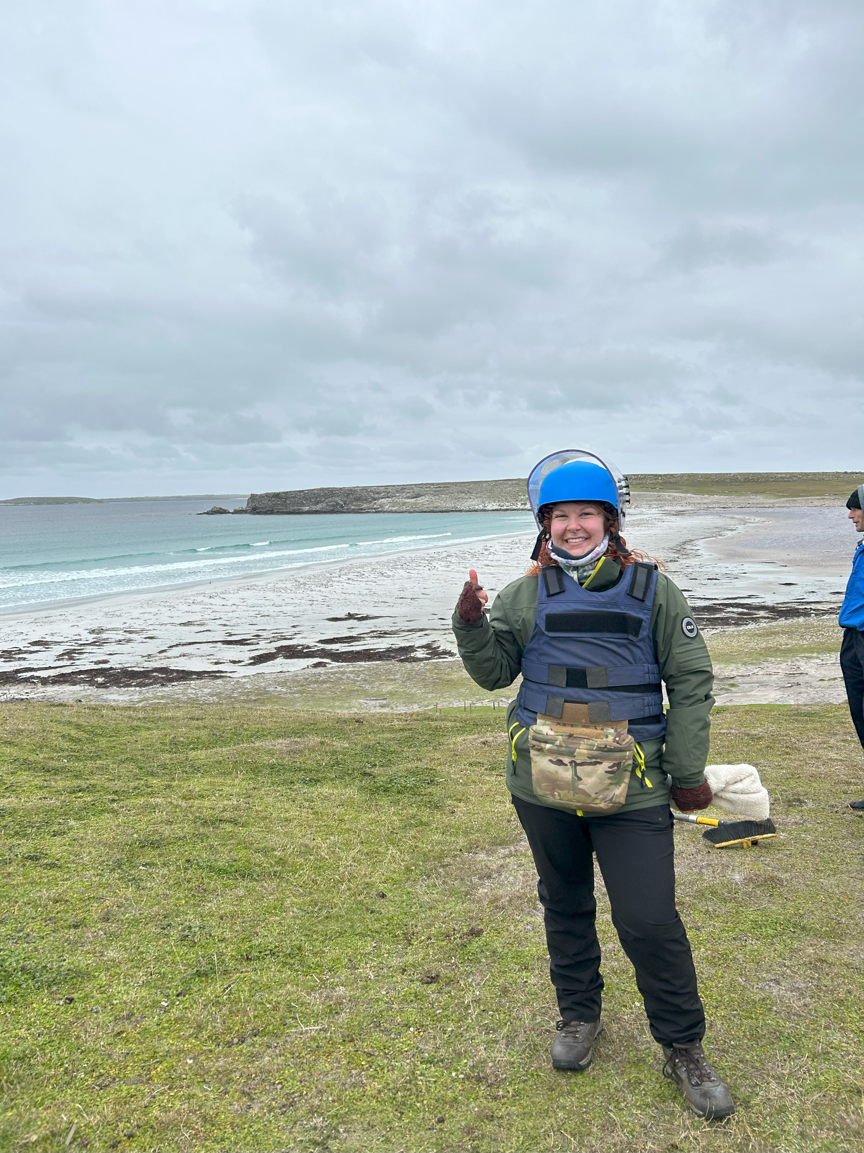 A woman in outdoor clothing and a helmet