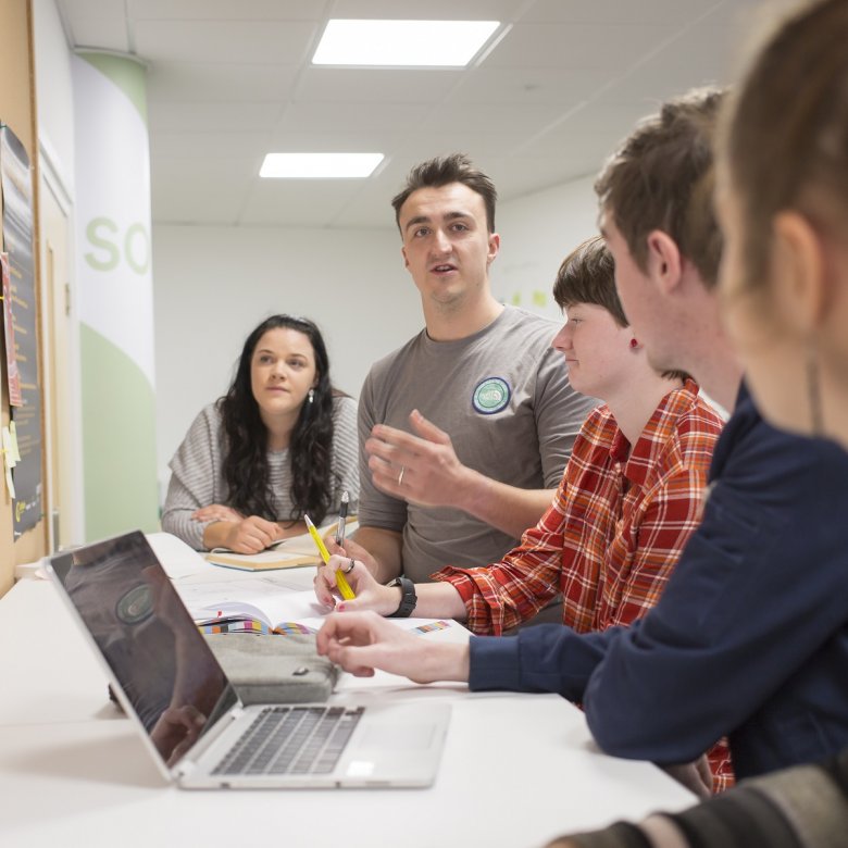 Falmouth University Entrepreneurship students in the studio with a laptop