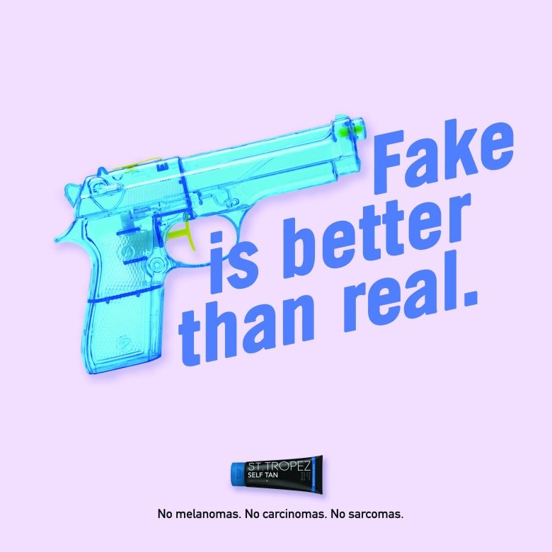 Blue toy gun with the text 'Fake is better than real'