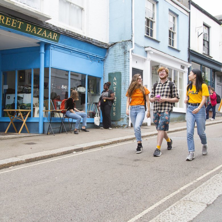 Three students walking down Falmouth high street