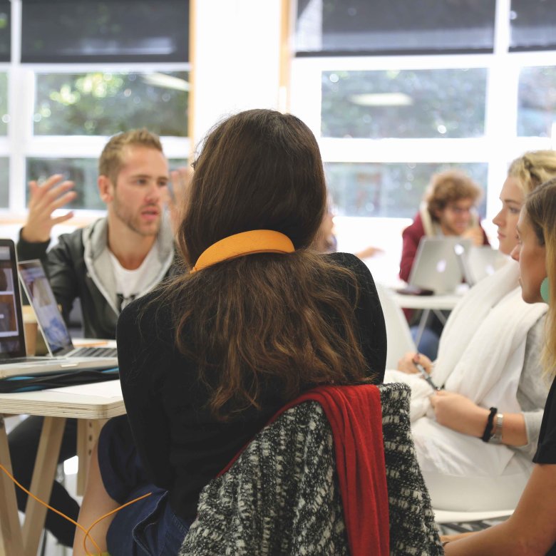 MA Graphic Design students chatting around a table