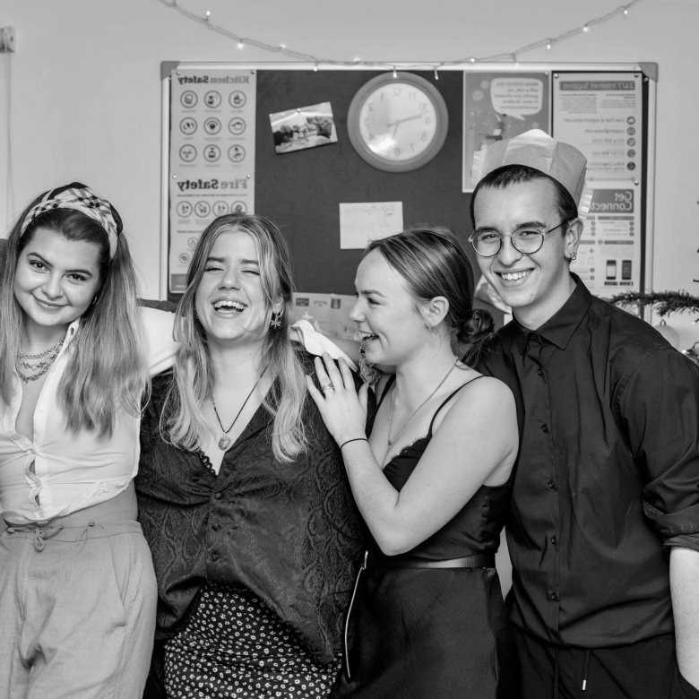 International student Orestis posing with friends at a Christmas party