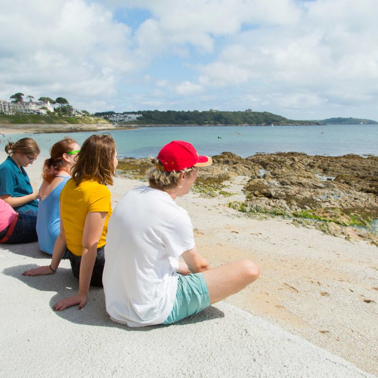 Students sat looking out to sea 