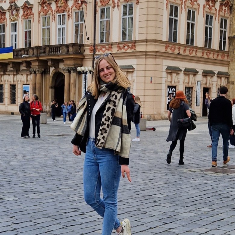 Master's student Inge stood outside a large building 