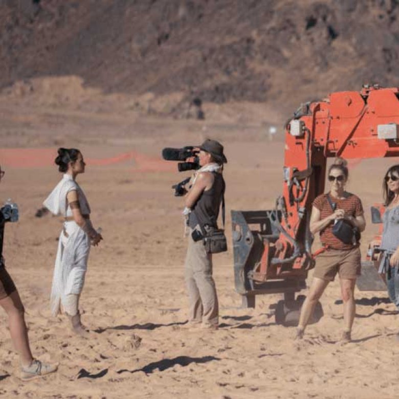 Four women shooting a documentary about the making of Star Wars on a desert-like set