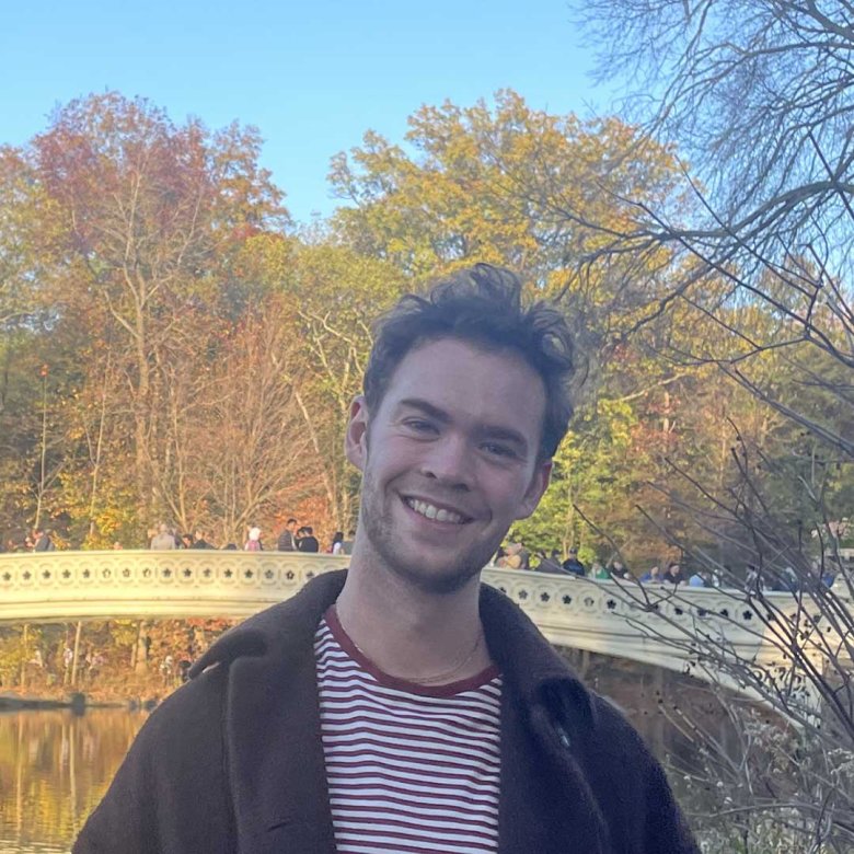 Student Tom Holmes standing in a park