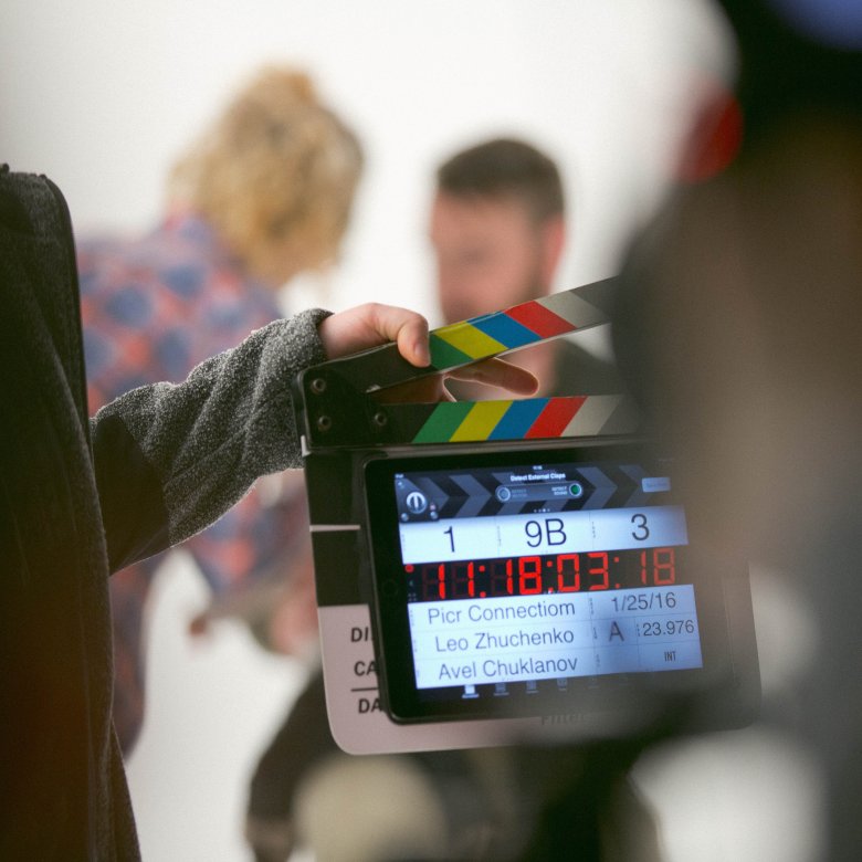 A filmmaker holding a clapper board 