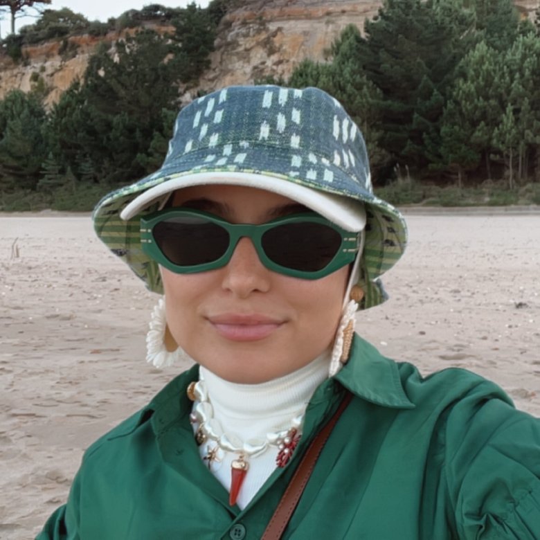 A woman wearing sunglasses and a hat