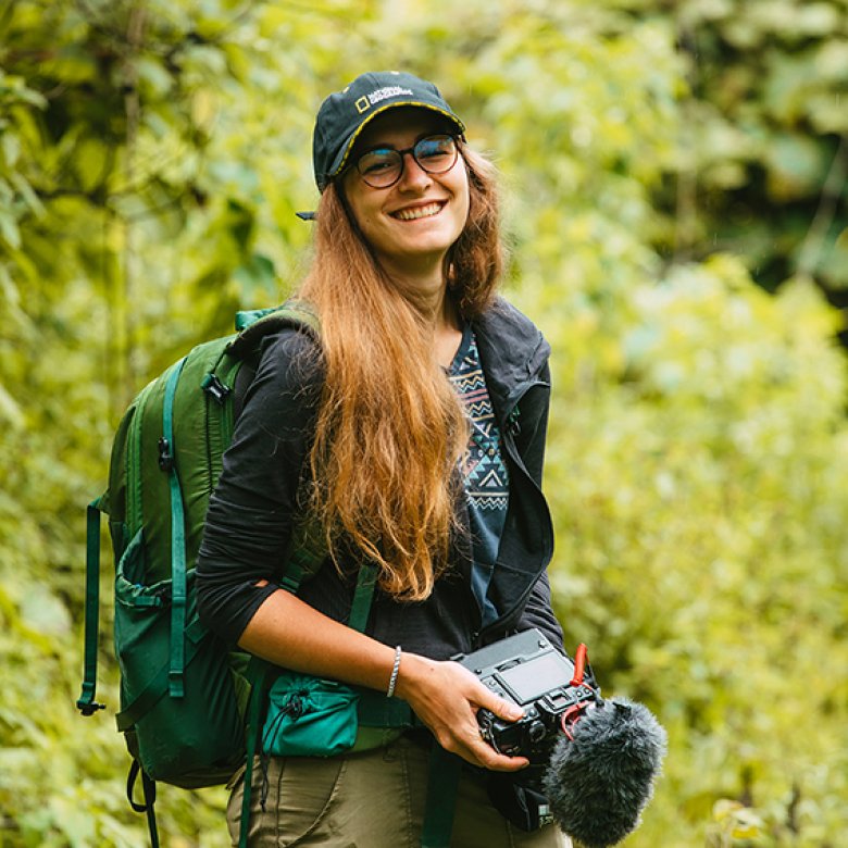 Hedvika Michnova on a location shoot carrying a camera 