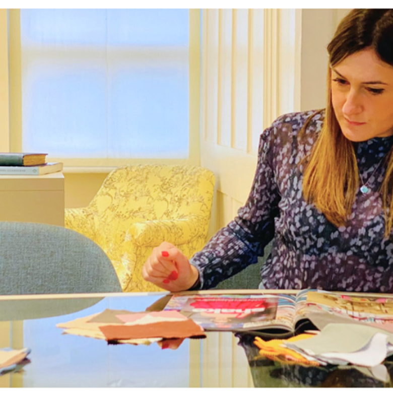 A woman sat at a desk drawing