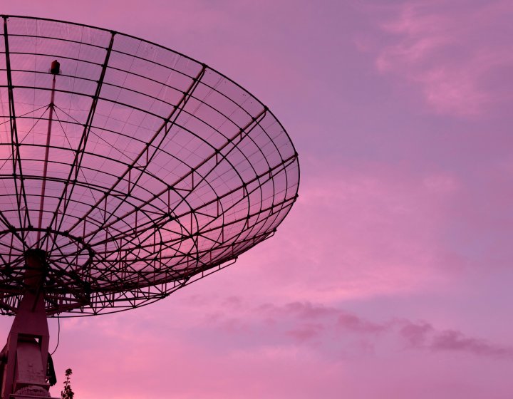 Satellite with sunset sky behind