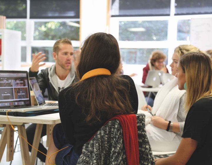 MA Graphic Design students chatting around a table