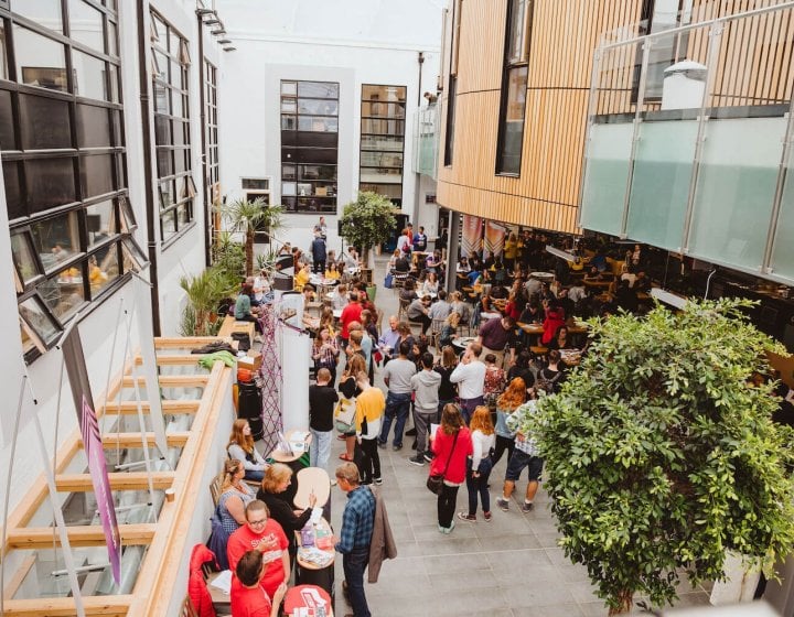 A crowd of parents and students at an Open Day inside Falmouth University's campus cafe