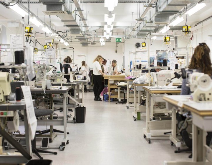 A view of the fashion department facilities at Falmouth University with tables with sewing machines.