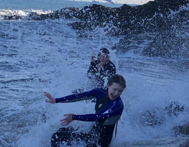 Two friends splash around in white water 