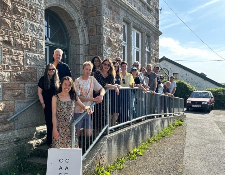 A group of students stood outside an old building in Helston, Cornwall