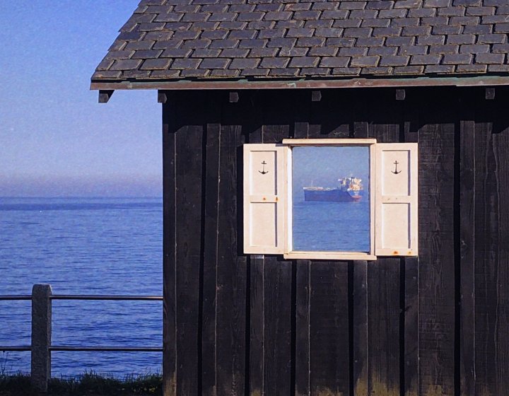 An open window reveals a large ferry 