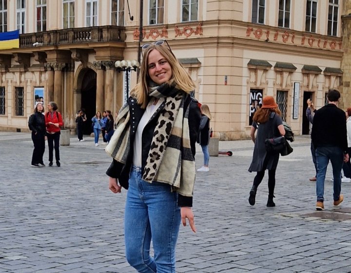 Master's student Inge stood outside a large building 