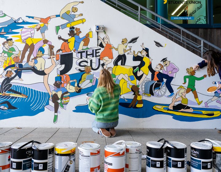 Students painting the Students' Union mural