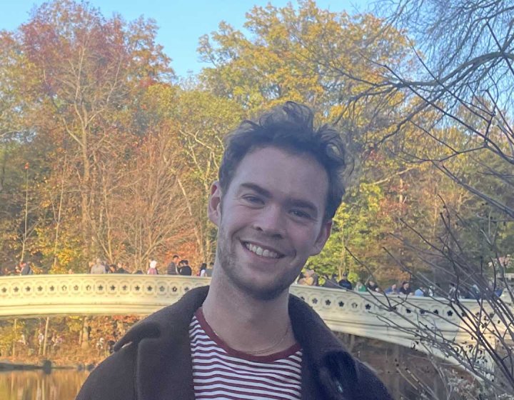 Student Tom Holmes standing in a park