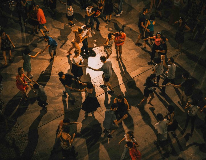 A cuban salsa dance class shown from above with lots of people dancing