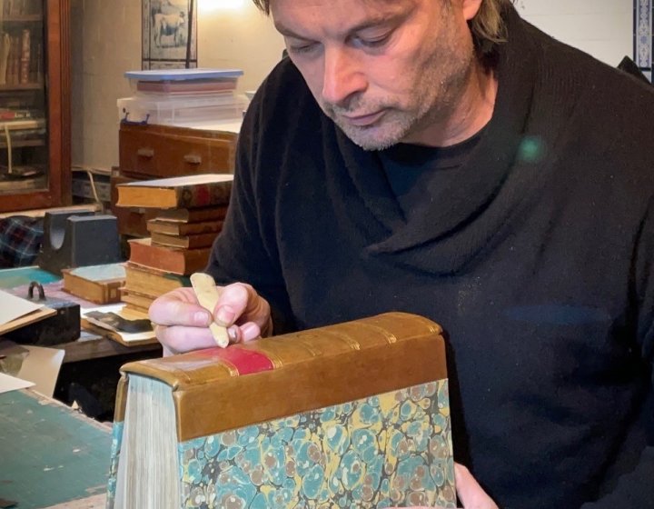 Bookbinder Tom O'Reilly doing Bookbinding