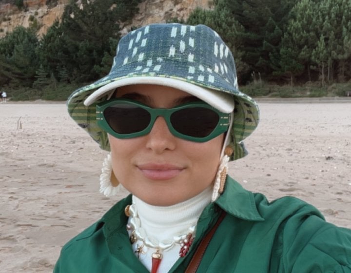 A woman wearing sunglasses and a hat