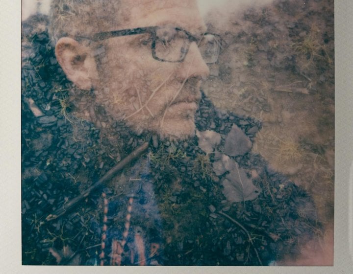 Polaroid of a man wearing glasses