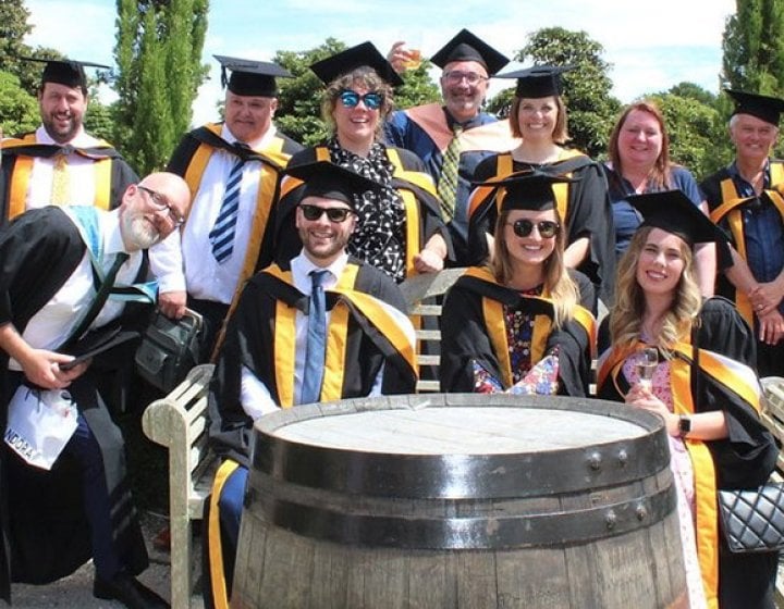 A group of Falmouth master's graduates sat together