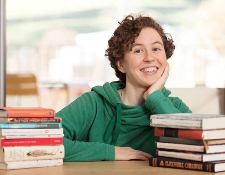 Hannah sitting with her books