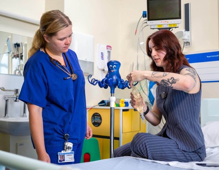 A Falmouth University student showing a healthcare professional her Octopus IV drip design