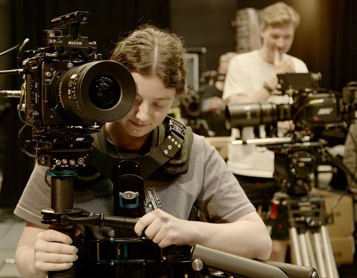 A female student operating an ARRI camera at Falmouth University