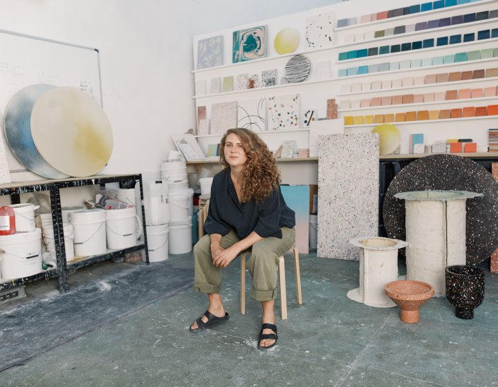 A woman sat on a chair in her studio