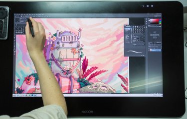 Animation student drawing a robot on a graphic tablet