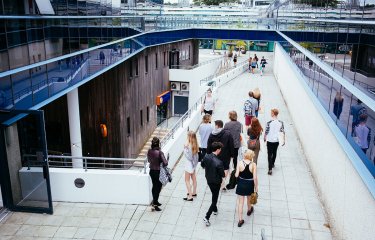 Group of students on walkway at Penryn campus.