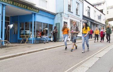 Three students walking down Falmouth high street