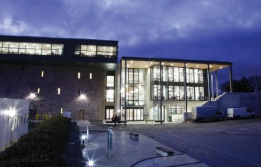 Penryn Campus glass building lit up at night