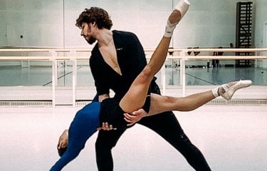 Two dancers from the Royal Opera House performing in a studio