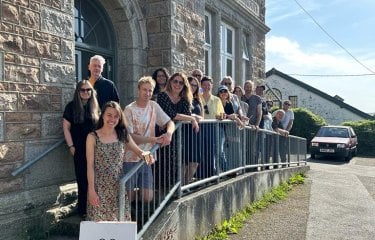 A group of students stood outside an old building in Helston, Cornwall