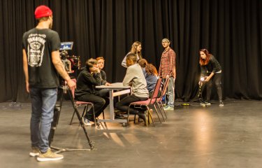 Photo of actors in rehearsal on a stage