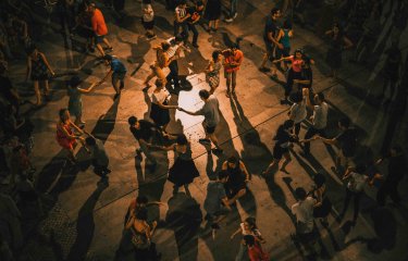 A cuban salsa dance class shown from above with lots of people dancing