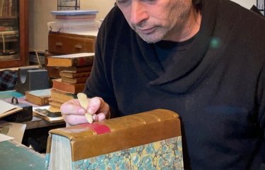 Bookbinder Tom O'Reilly doing Bookbinding