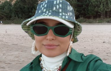 A woman wearing sunglasses and a hat