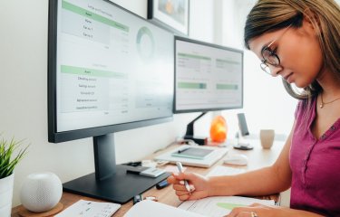 Person sat at a computer looking at data