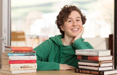 Hannah sitting with her books